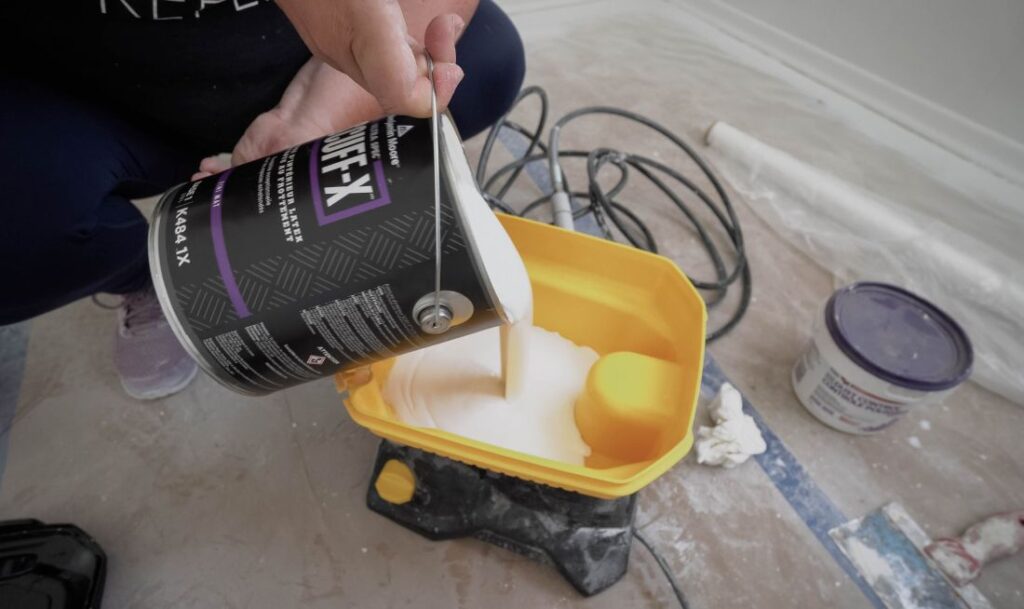 pouring paint into Control Pro 130 paint and stain sprayer
