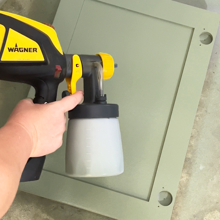 spraying paint on cabinet doors